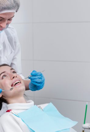 female-dentist-performing-dental-check-patient